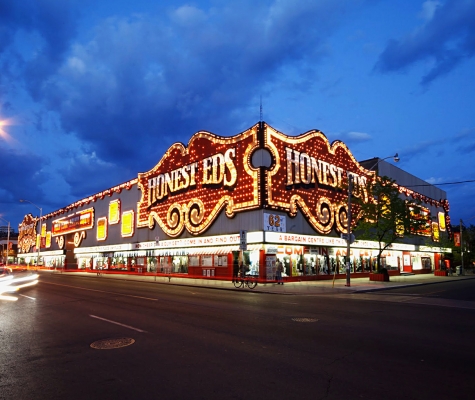 Photograph of iconic Honest Eds store, illuminated at night.